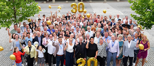 Foto: Aufnahme einer großen Gruppe von Personen und einer großen goldenen Dreißig